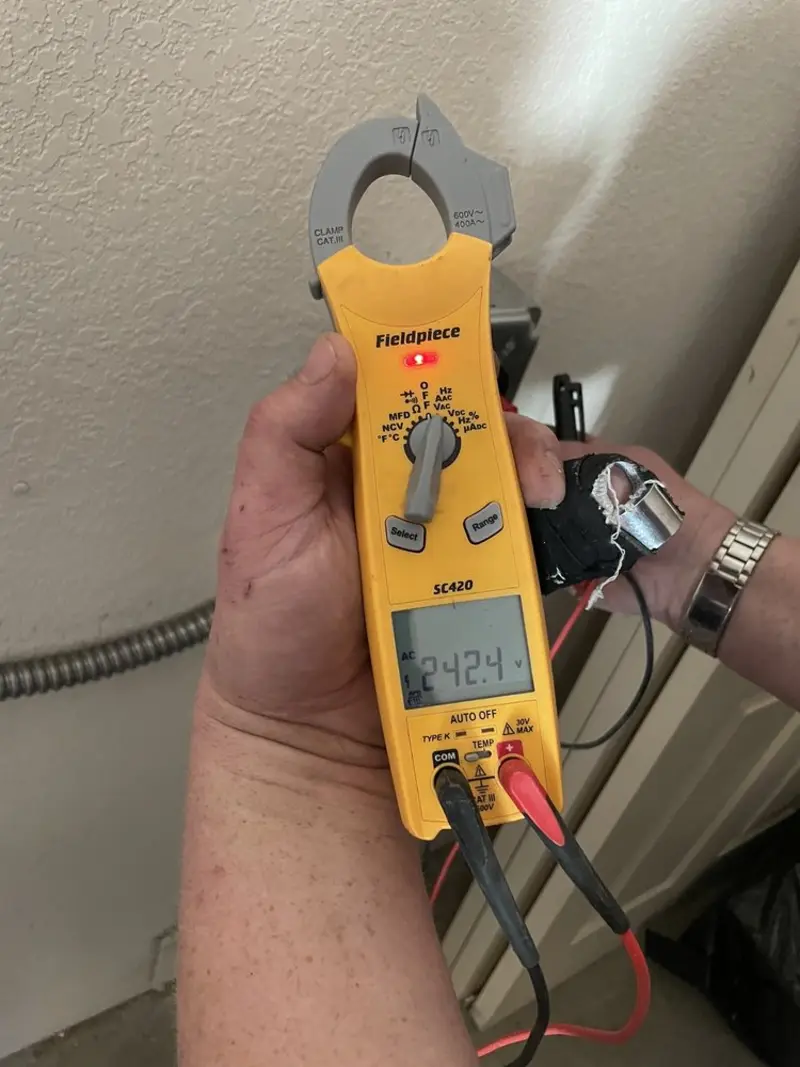 Voltage testing with clamp meter during Whole House Surge Protector in Tulsa